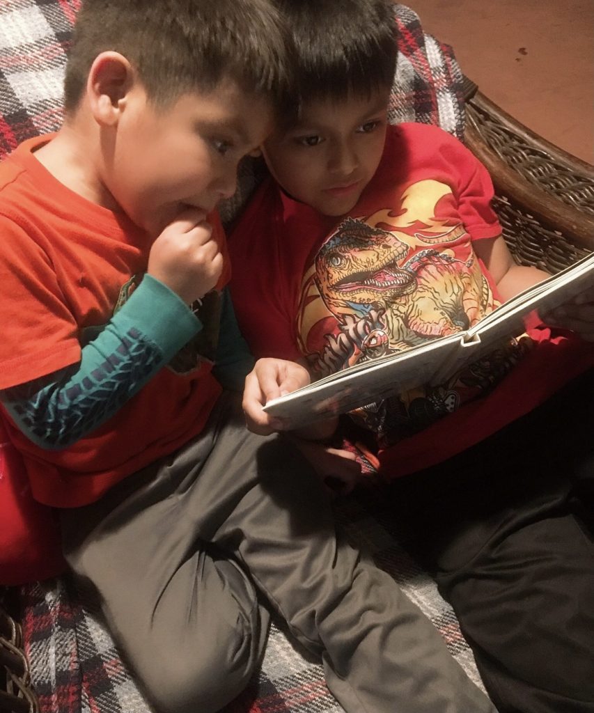 Boys reading together to complete reading challenge