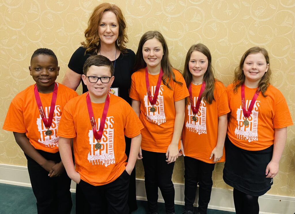 On March 31st-April 2nd, these New Albany Elementary students participated in the MMEA All State Elementary Honor Choir hosted at the University of Southern Mississippi . Pictured are Brandon Miles, Max  Bullock, Bristol Nanney, Arden Nanney, and Emma Denning with their teacher and All State Elementary Honor Choir Chair,  Celia Criddle.  Bristol Nanney was one of 5 students out of 169 that was recognized for having a perfect audition score.