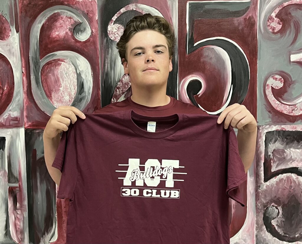 New Albany High School presented an ACT 30+ Club t-shirt to Matthew Harris on April 14, 2022 for his recent success on the ACT.   Students who have a composite or subscore of 30 or more on their recent ACT are inducted into the club.  More than 200 students have become members of the ACT 30+ Club since its creation in the fall of 2009.