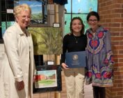 Allie Bullock, a sophomore at New Albany High School, is the 2023 winner of The Congressional Art Competition sponsored by the members of the United States House of Representatives. Her painting will be displayed for one year in the United States Capitol. Allie and her family will travel to Washington DC in June. Pictured left to right are Dr. Barbara McMillin, President of Blue Mountain Christian University; Allie Bullock; Emily Murff, NAHS Art Teacher.