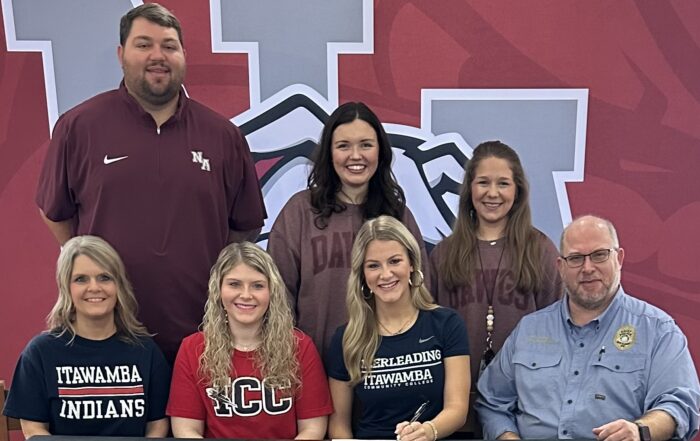 New Albany High School senior cheerleader Logan Lee Robertson was surrounded by friends and family as she signed with Itawamba Community College Cheer on Friday, January 26, 2024. Pictured are front row l-r: Neely Robertson, Bailey Robertson, Logan Lee Robertson, Chris Robertson; back row l-r: NAHS Athletic Director Cody Stubblefield, NAHS Cheer Coach Allie Pierce, and NAHS Cheer Coach Mary Scott Sanks.
