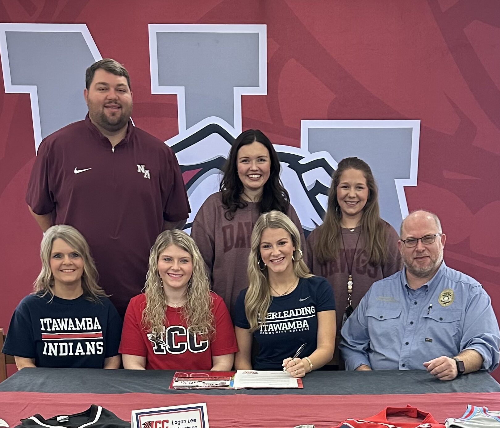 New Albany High School senior cheerleader Logan Lee Robertson was surrounded by friends and family as she signed with Itawamba Community College Cheer on Friday, January 26, 2024. Pictured are front row l-r: Neely Robertson, Bailey Robertson, Logan Lee Robertson, Chris Robertson; back row l-r: NAHS Athletic Director Cody Stubblefield, NAHS Cheer Coach Allie Pierce, and NAHS Cheer Coach Mary Scott Sanks.