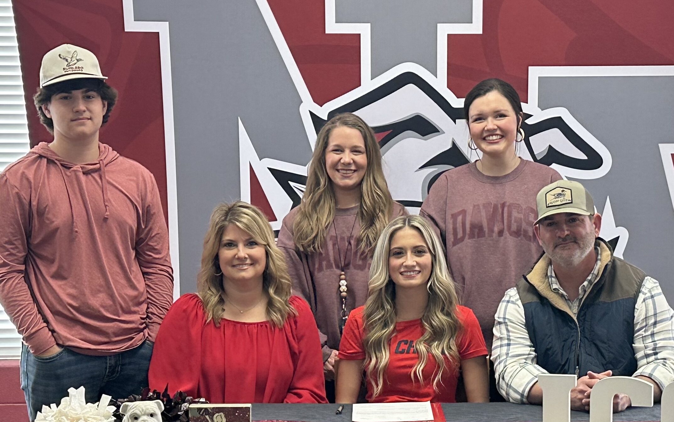 New Albany High School senior cheerleader Addi Owen was surrounded by friends and family as she signed with Itawamba Community College Cheer on Tuesday, February 20, 2024. Pictured are front row l-r: Eva Owen, Addi Owen, Brett Owen; back row l-r: Aden Owen, NAHS Cheer Coach Mary Scott Sanks, and NAHS Cheer Coach Allie Pierce.