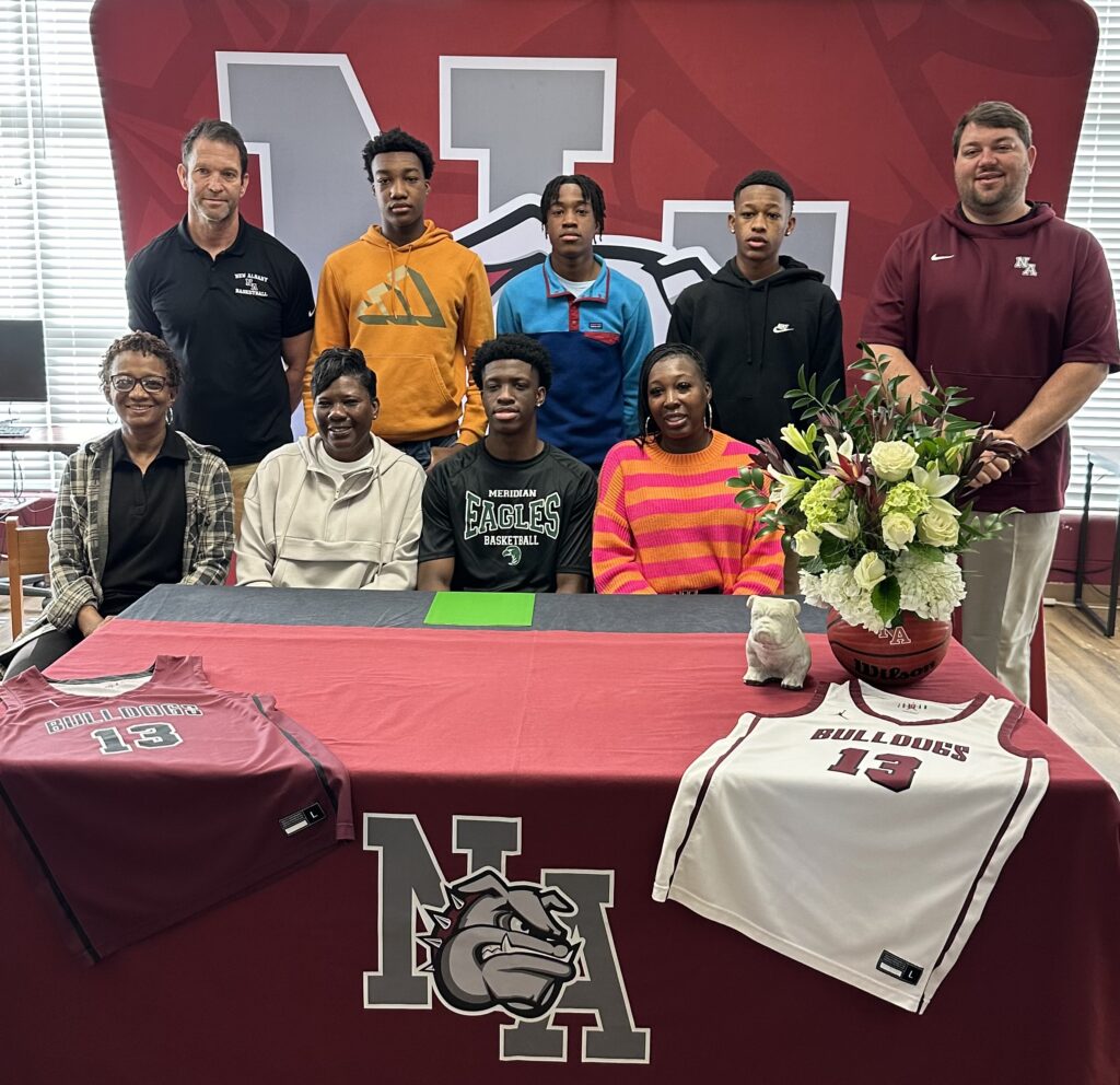 On Friday, April 12 New Albany Bulldog Boys Basketball's Kylan Lindsey signed to play basketball with Meridian Community College. Pictured front row l-r: Xavier Tillman, Barbara Washington, Kylan Lindsey, and Portia Dixon; back row l-r: Scotty Shettles, NAHS Head Boys Basketball Coach, Kameron Carruthers, Kayden Carruthers, Kamari Johnson, and Cody Stubblefield, NAHS Athletic Director 